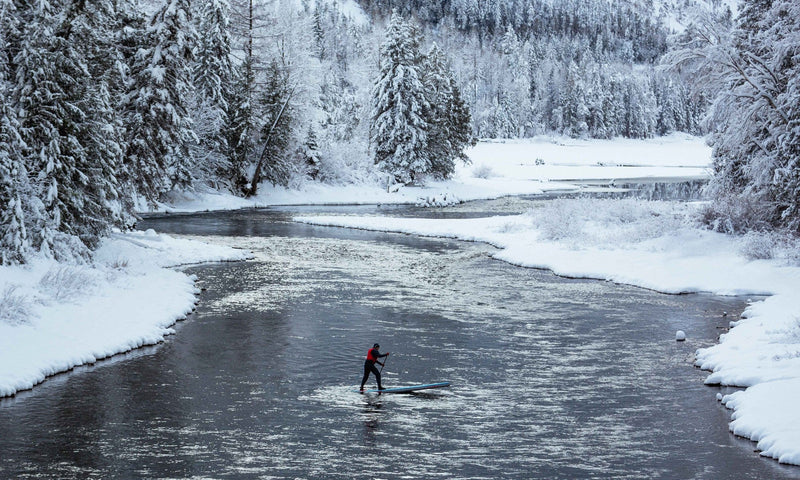 paddle boarding in a snowy creek